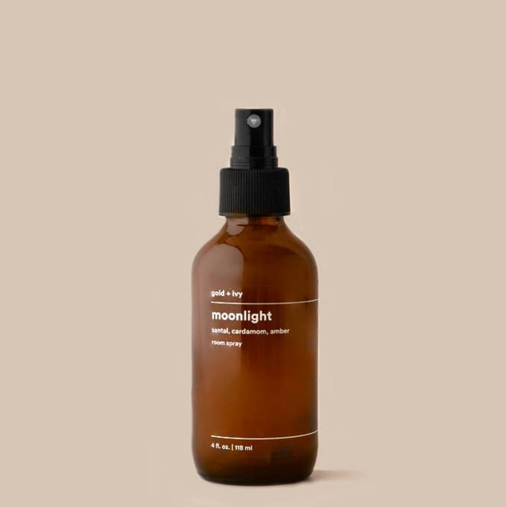 Pictured is our prized Moonlight Roomspray amidst a neutral tan background.