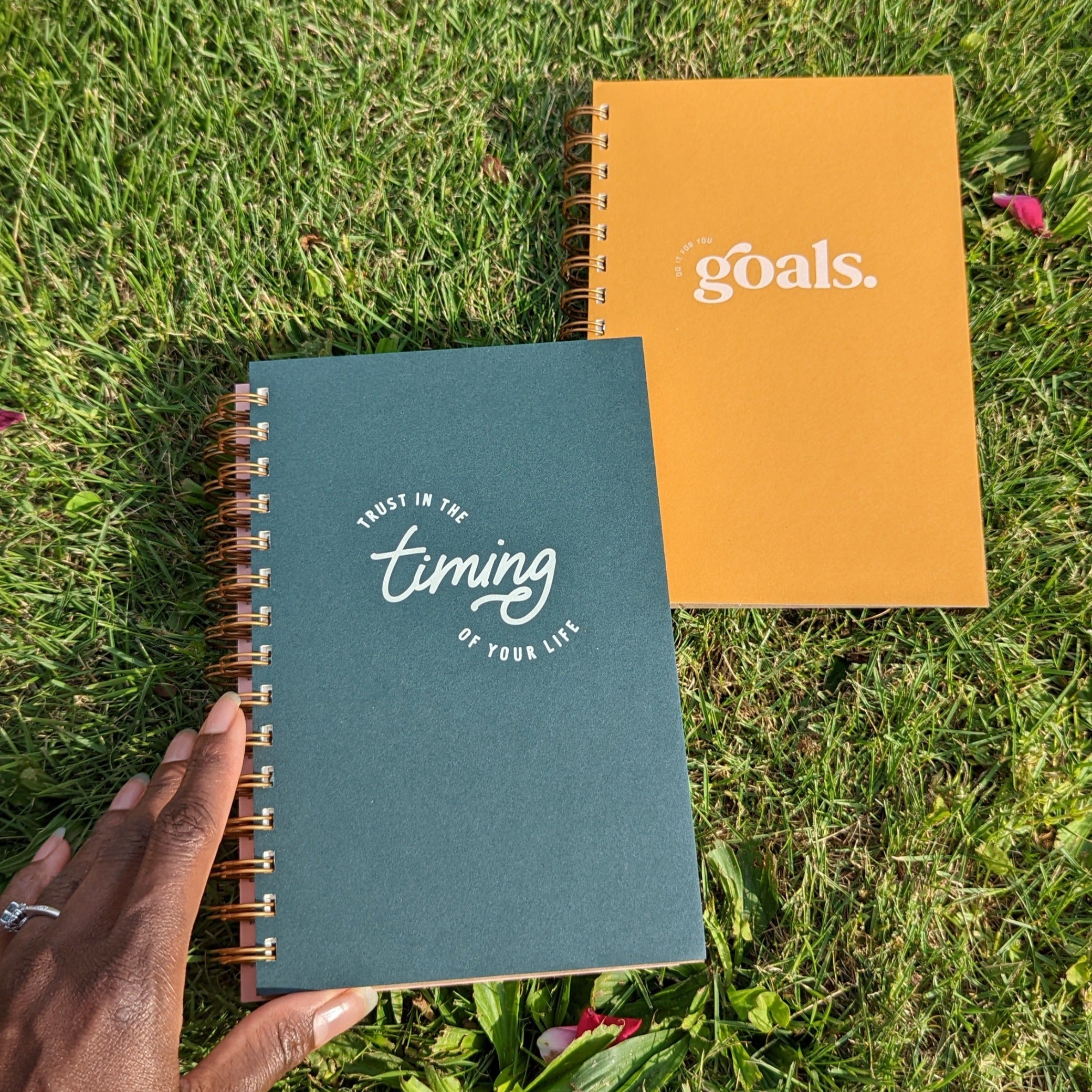 Lie among the grass with us, as pictured, to unpack your mind within Trust in the Timing of Your Life Journal Planner or Do it For the Goals Journal Planner. 