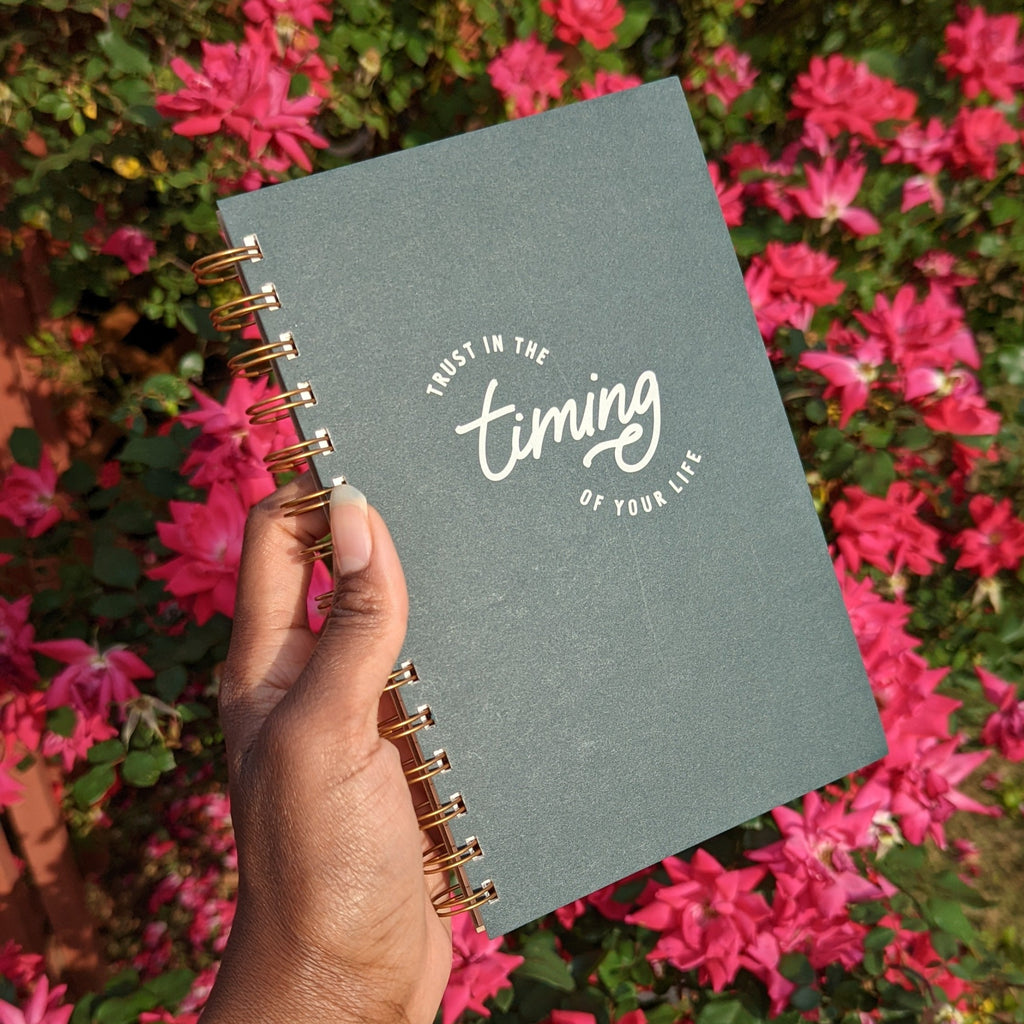 Stop and smell the flowers with this image of Trust in the Timing of Your Life Journal Planner, in forest green, amongst the ruby red roses.