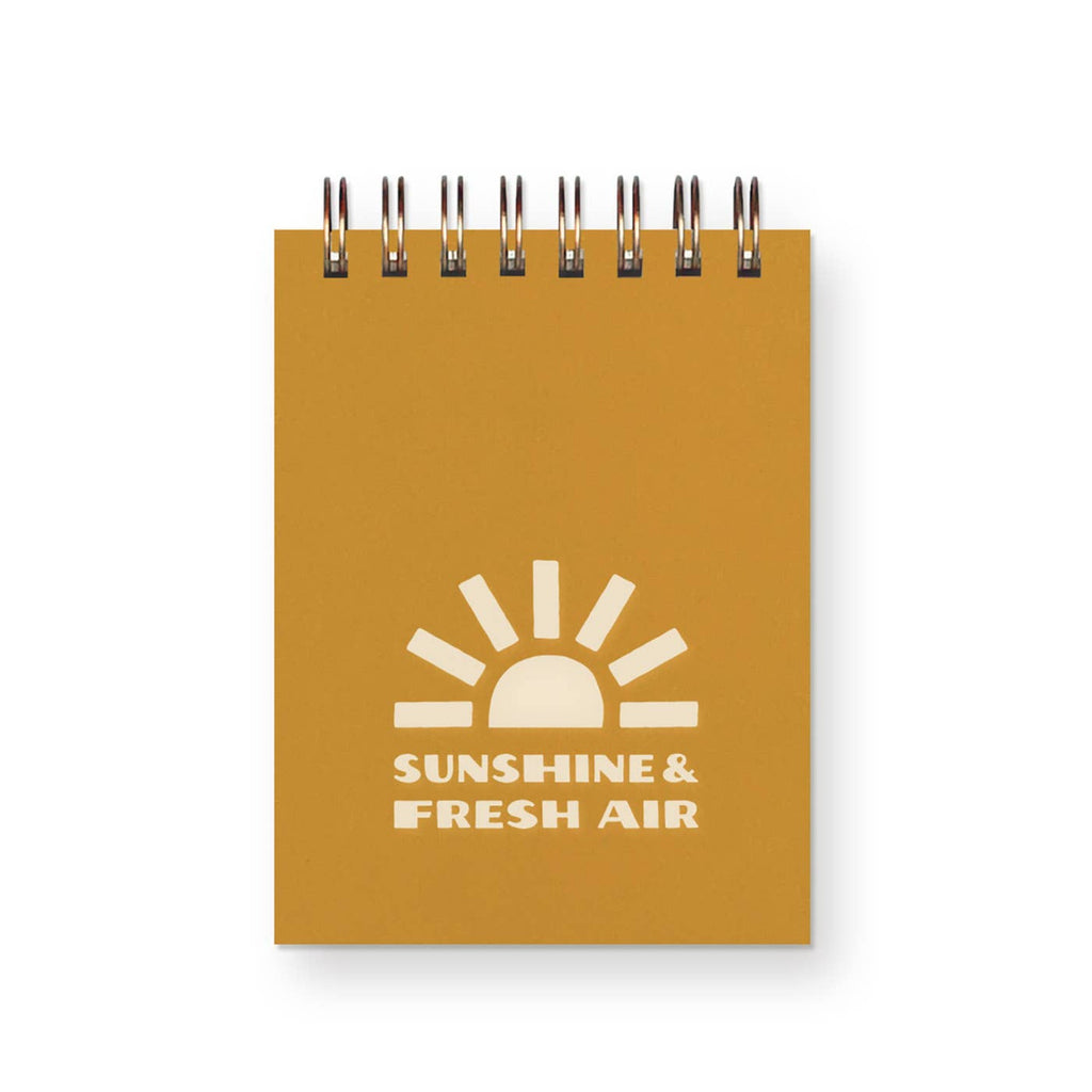 Pictured is the bright, sunny yellow cover of our Sunshine & Fresh Air mini jotter with a golden spiral binder to keep this cutie patootie notepad in tact. 
